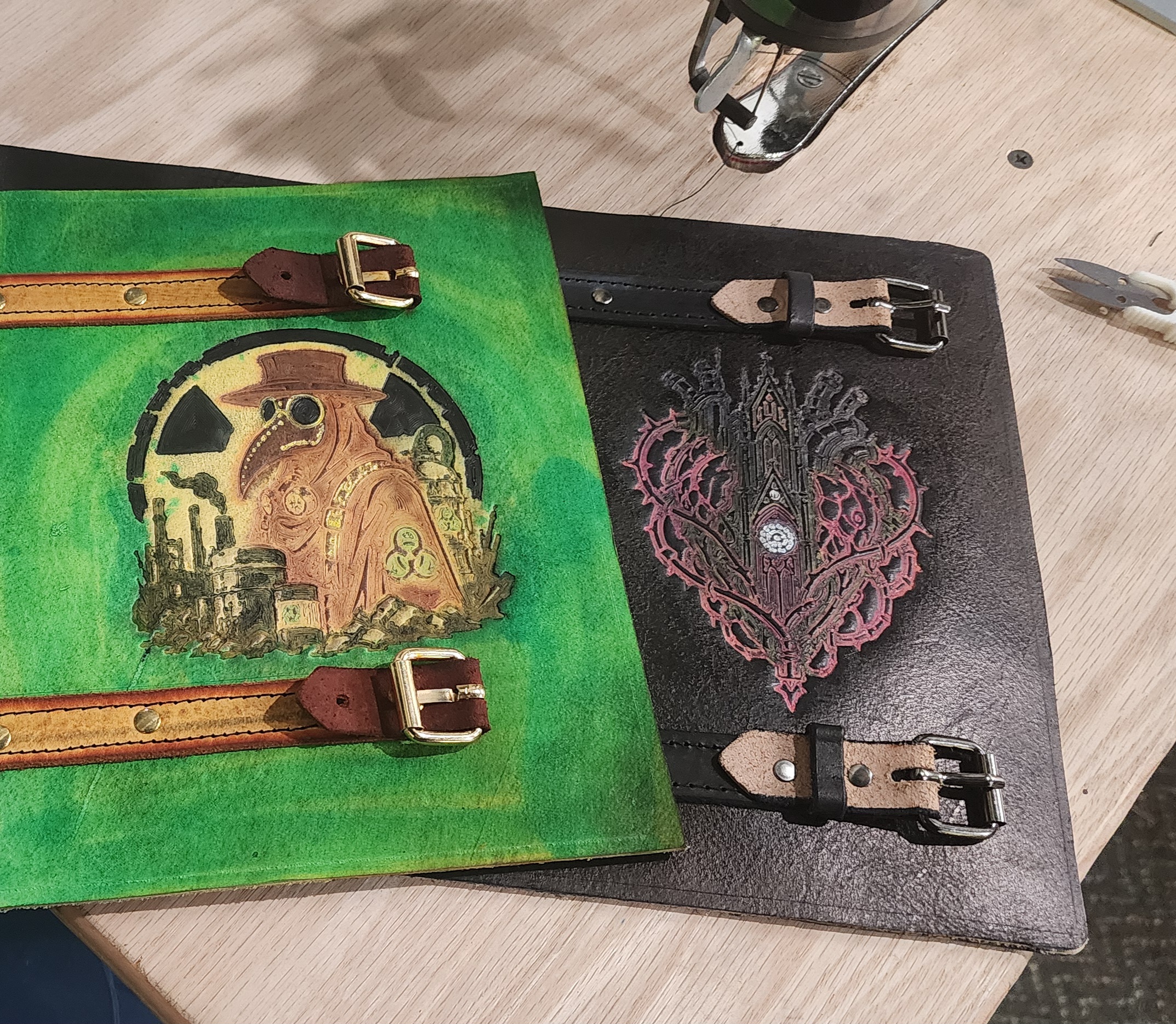 In-progress leather journal covers on the bench at Horizon Creations