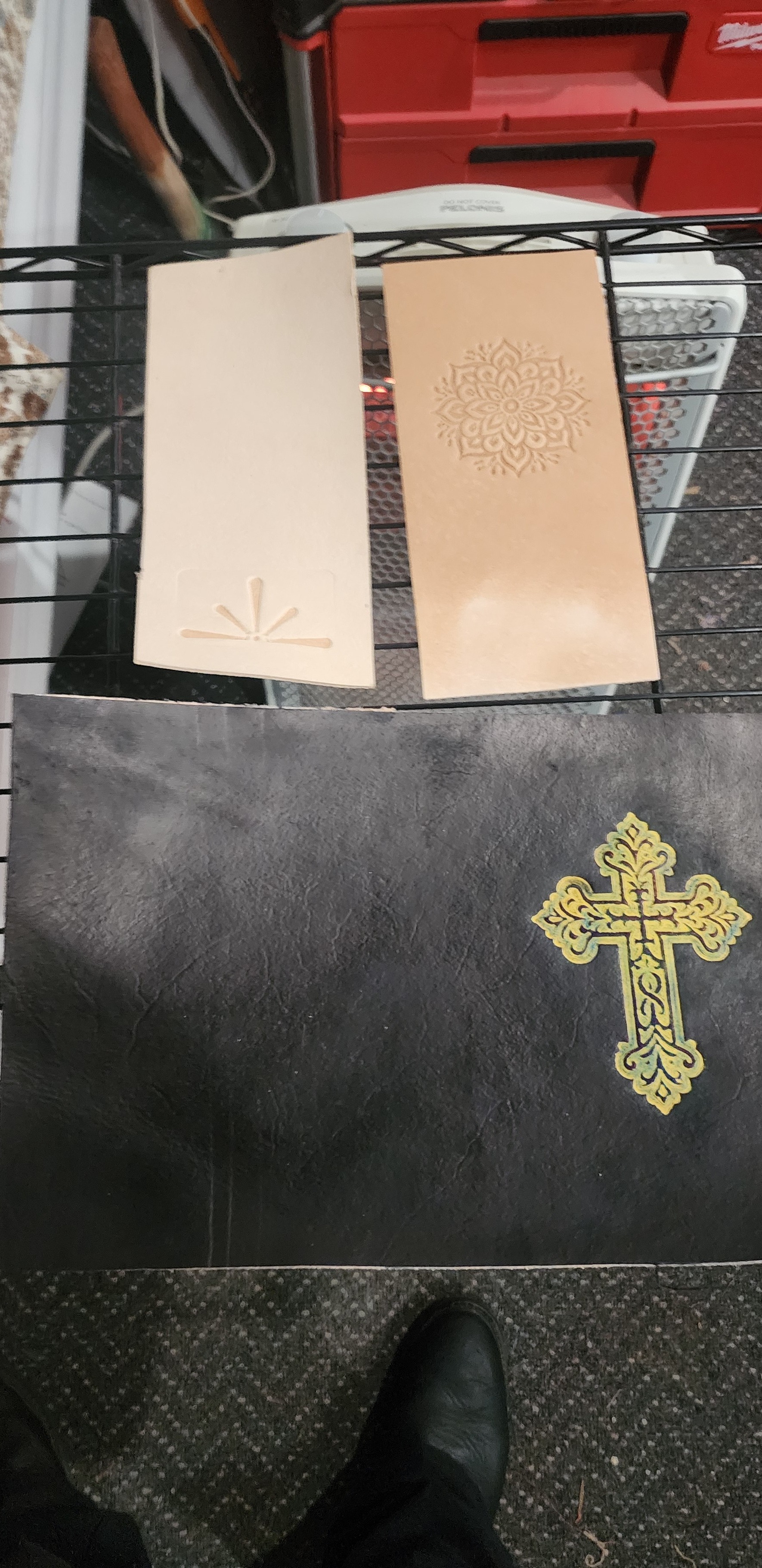 Leather tooling test pieces and printed blocks on the Horizon Creations bench